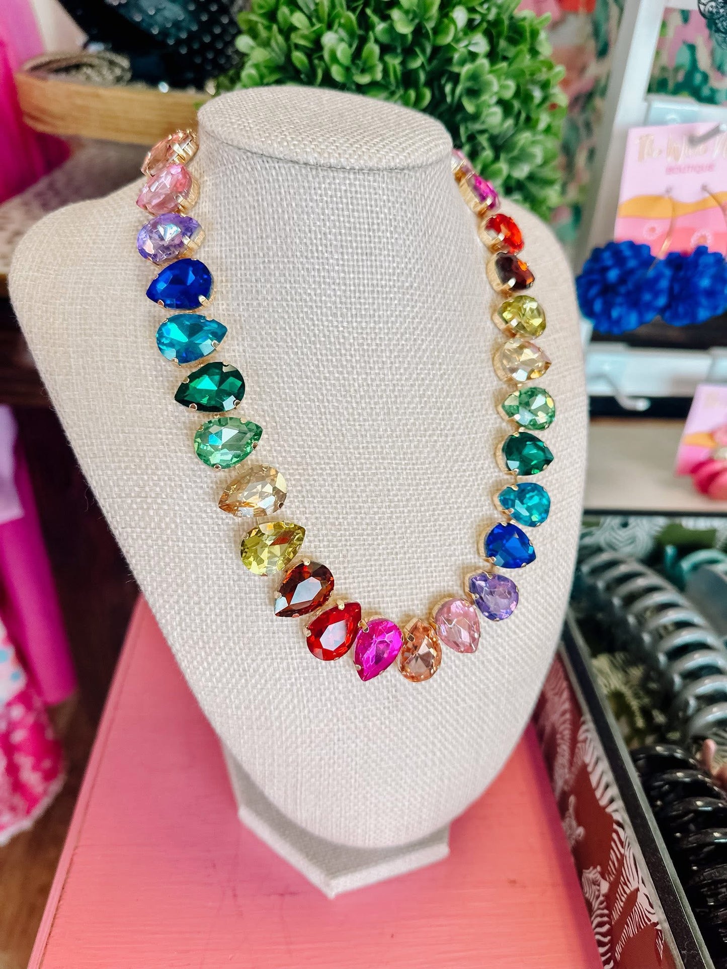 Colorful teardrop crystal statement necklace on display bust, women's fashion jewelry