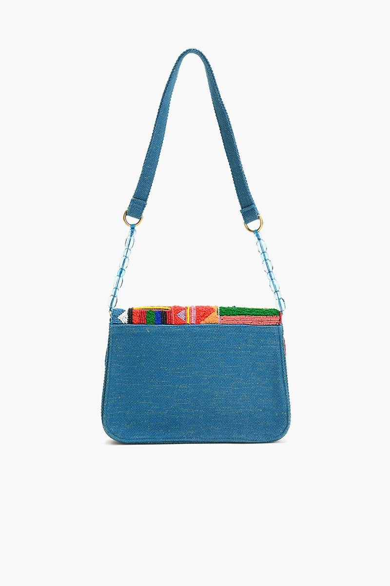 "Back view of a teal blue shoulder bag with a plain fabric panel and beaded strap detailing, showcasing the colorful geometric beading peeking over the top."