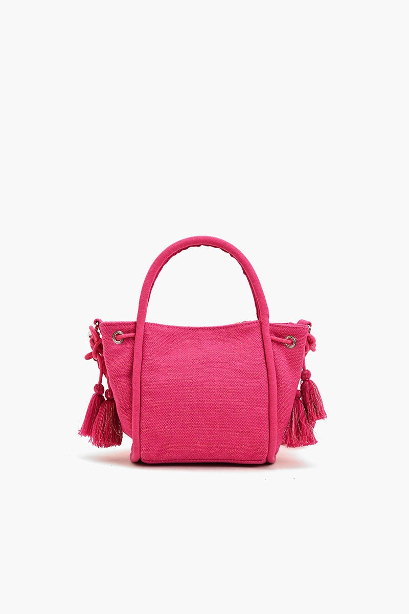 "Back view of a hot pink fabric crossbody bag featuring side tassels and a clean, minimal design without embellishments."