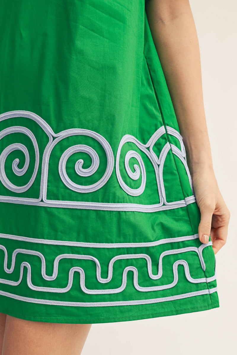 Green dress with white spiral patterns on a plain background