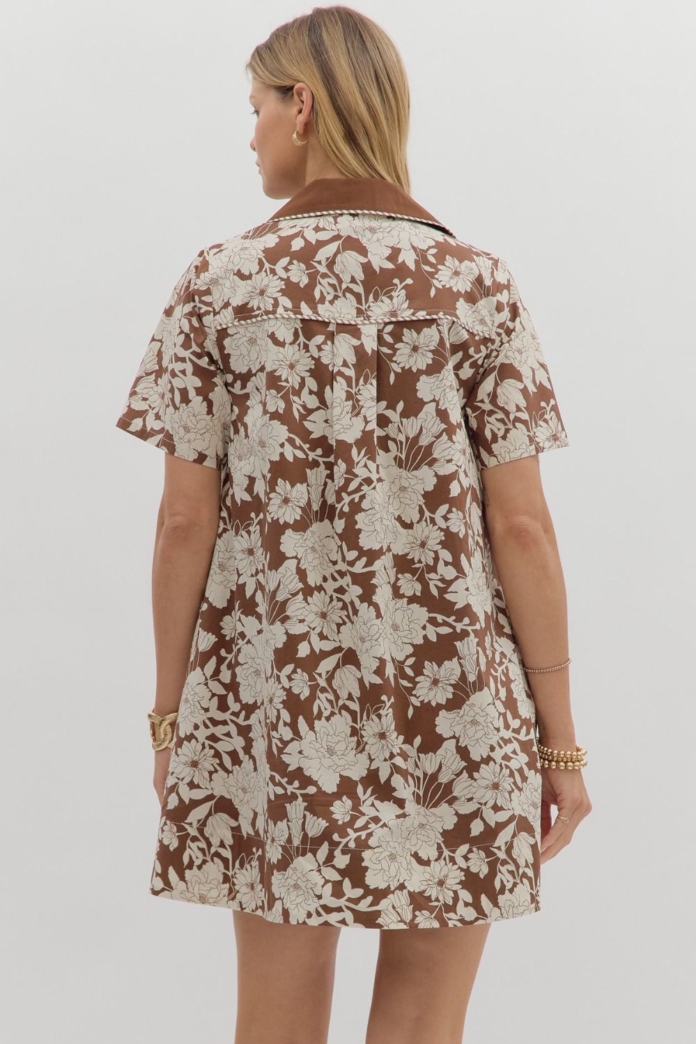 Back view of the Espresso Flora Dress showing espresso brown fabric with oversized ivory floral print and relaxed A-line silhouette – Milo & Lily Boutique.