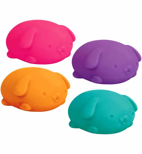 Four colorful pup-shaped bath bombs on a white background
