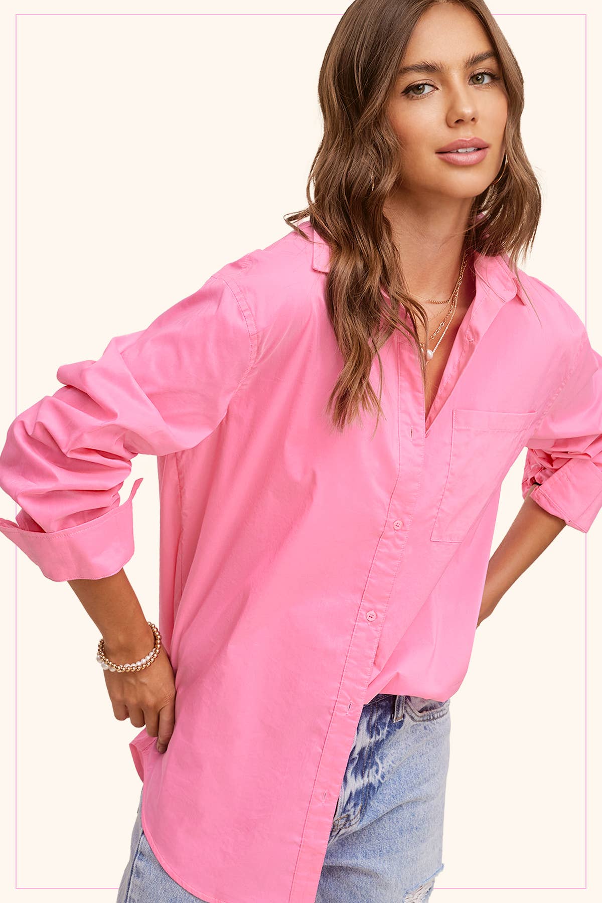 Woman wearing a pink shirt with rolled-up sleeves on a white background