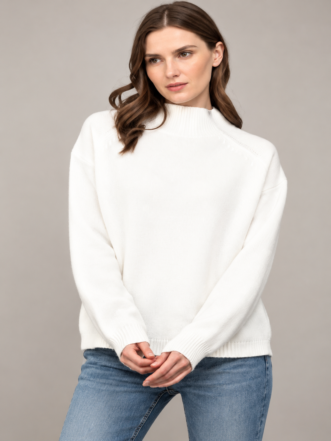 Women’s ivory round neck sweatshirt featuring zipper trim detailing, long sleeves, and a relaxed silhouette styled with blue denim jeans.