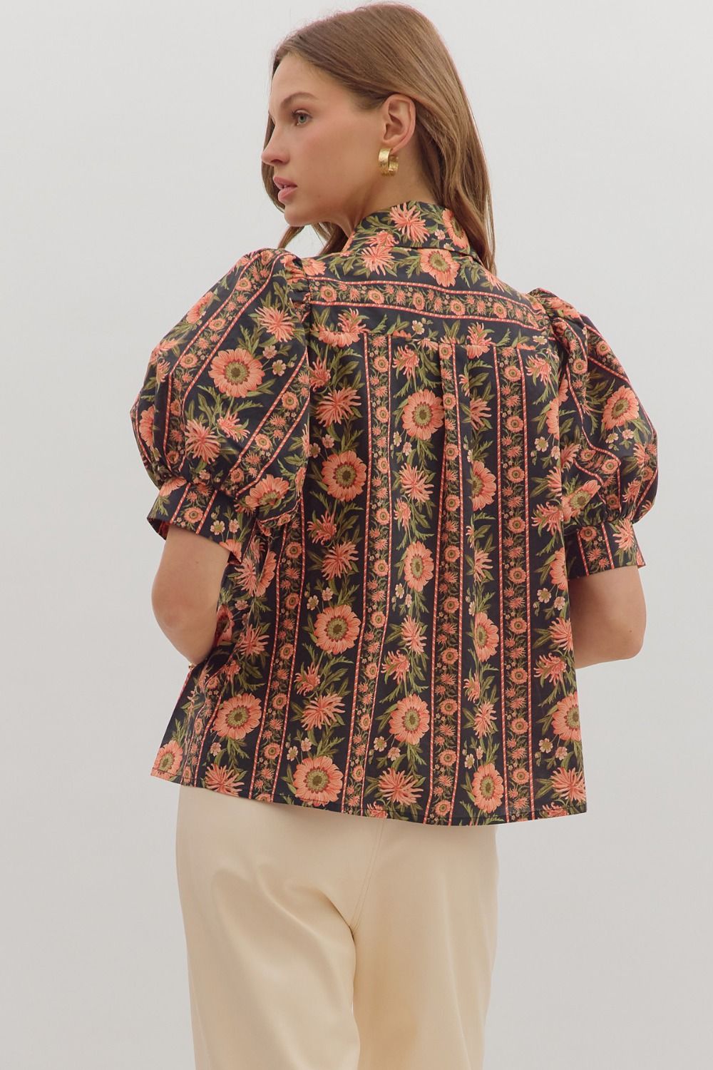 Stylish puff sleeve collared blouse with bold coral and green floral stripes on black fabric — boutique statement top