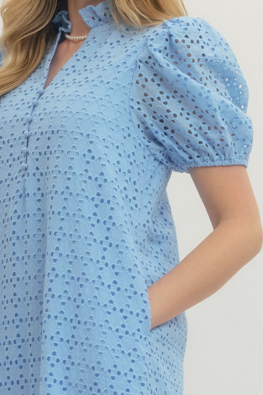 Light blue dress with puff sleeves worn by a person on a plain background