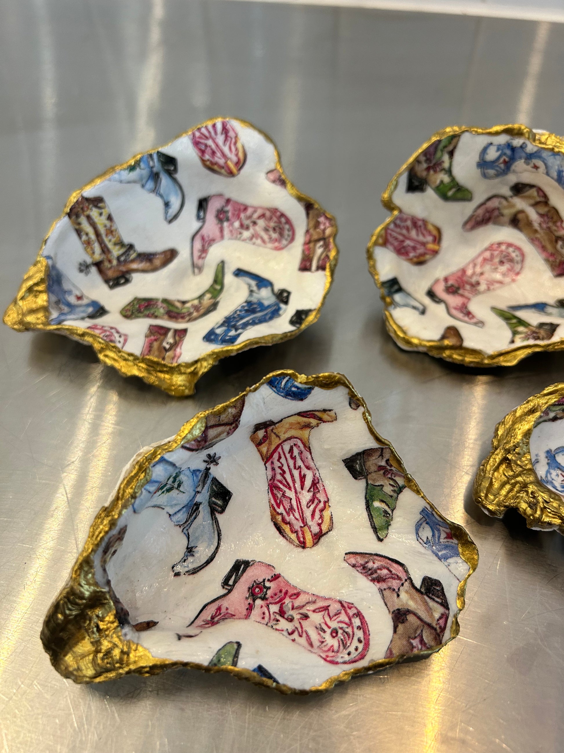 Decorative oyster shell dishes with colorful cowboy boot pattern and gold painted edges