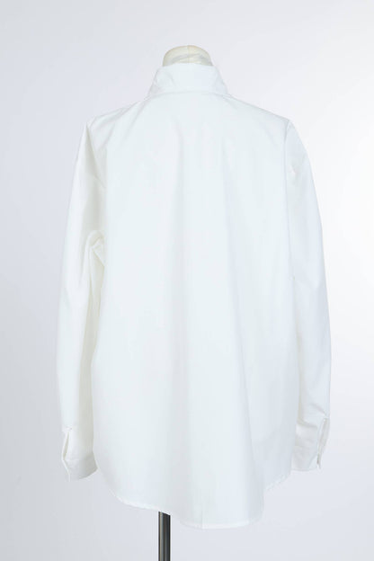Back view of a long sleeve white women's blouse on mannequin against white background