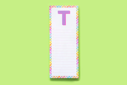 Colorful notepad with letter T, rainbow border, lined list on light green background