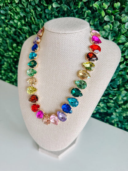 Colorful gemstone statement necklace with teardrop crystals on display bust