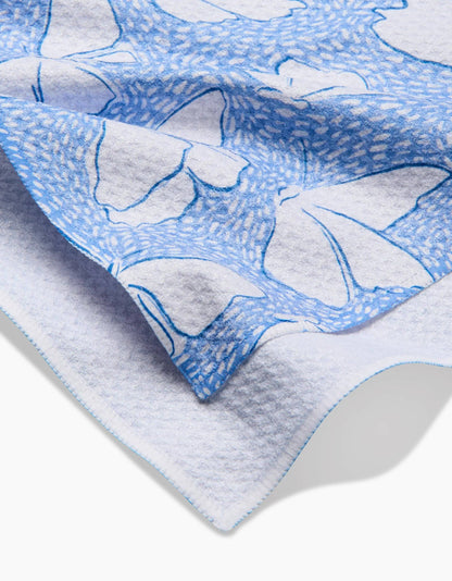 White textured towel with blue butterfly print and decorative stitched edge