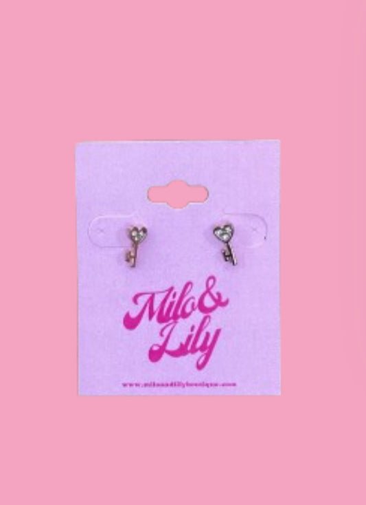 Heart-shaped key stud earrings with rhinestones on lavender card, pink background
