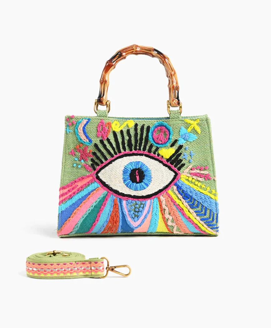 Colorful embroidered handbag with eye design, bamboo handle, and detachable strap