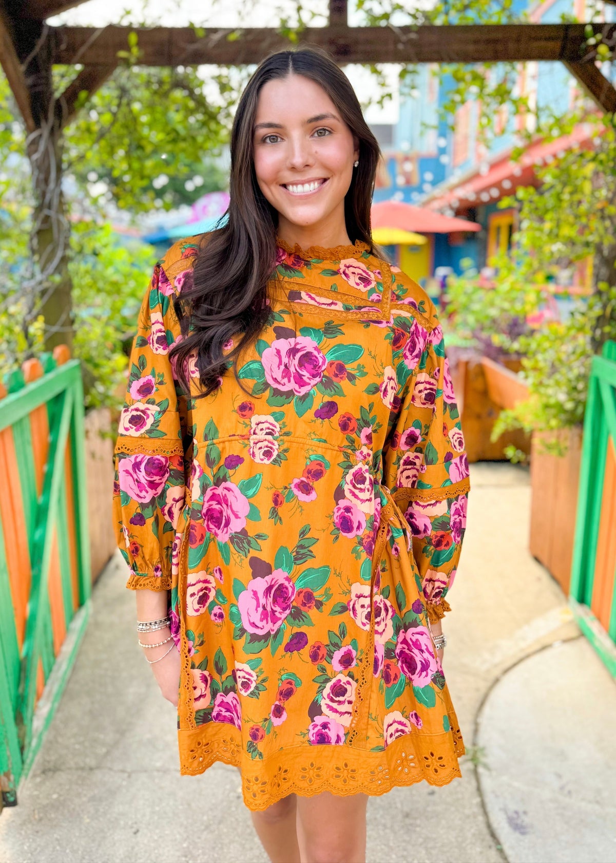 Woman wearing a floral long sleeve yellow dress outdoors, women's fashion photography