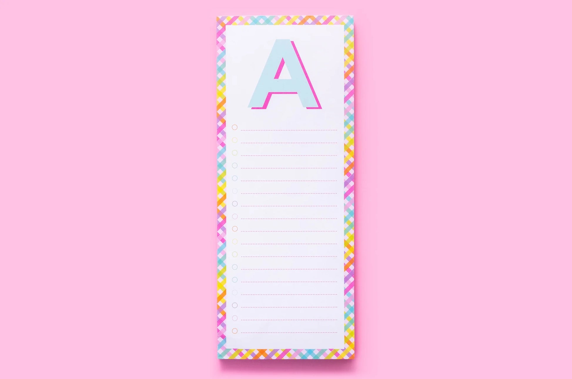 Colorful notepad with letter A, rainbow border, on pink background, stationery gift