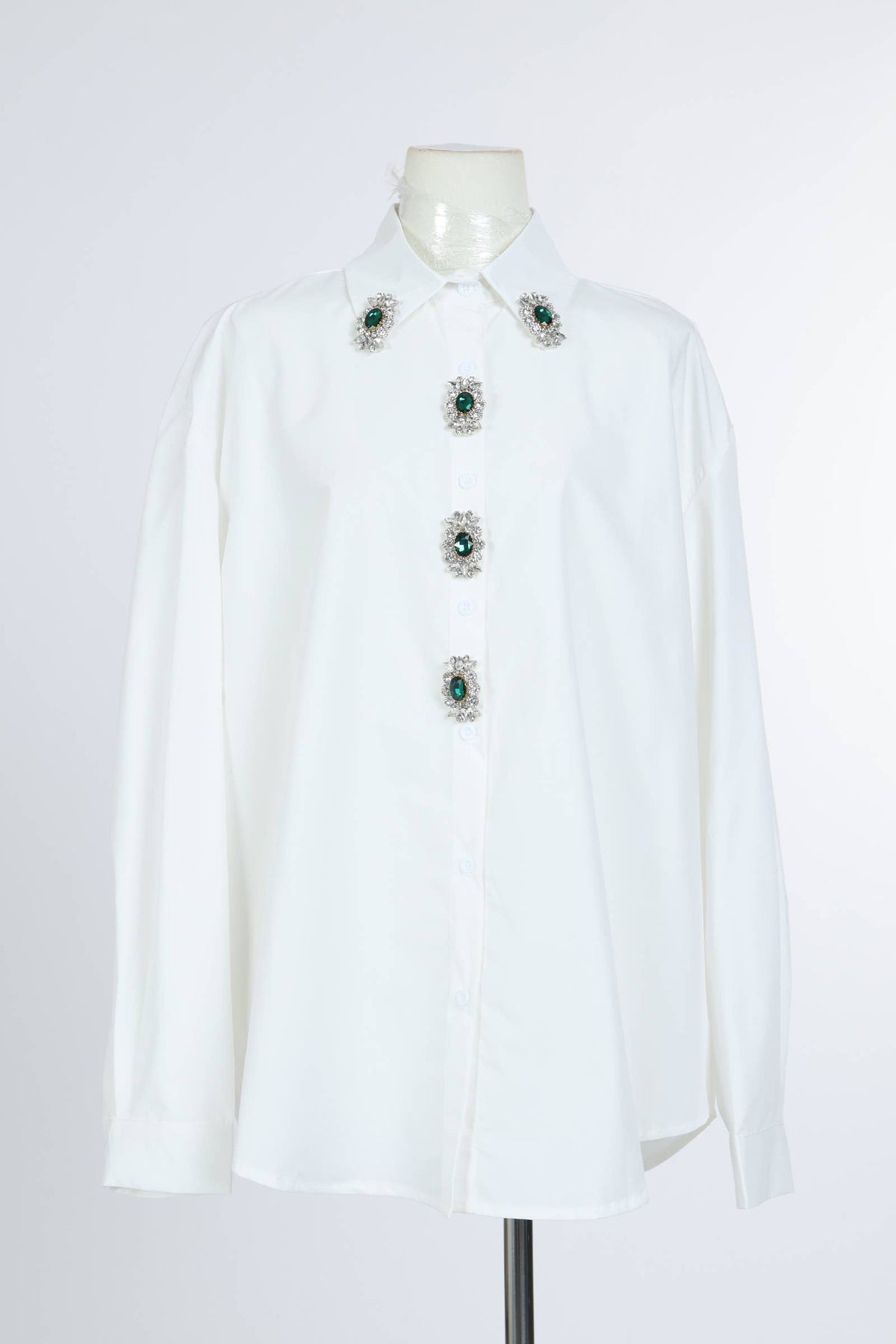 White long sleeve blouse with oversized fit and green jeweled button embellishments