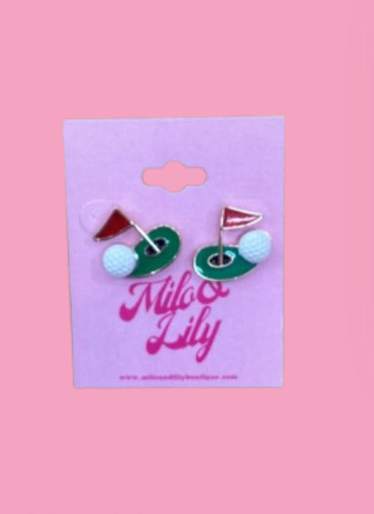 Golf-themed stud earrings with golf ball and flag on a pink display card