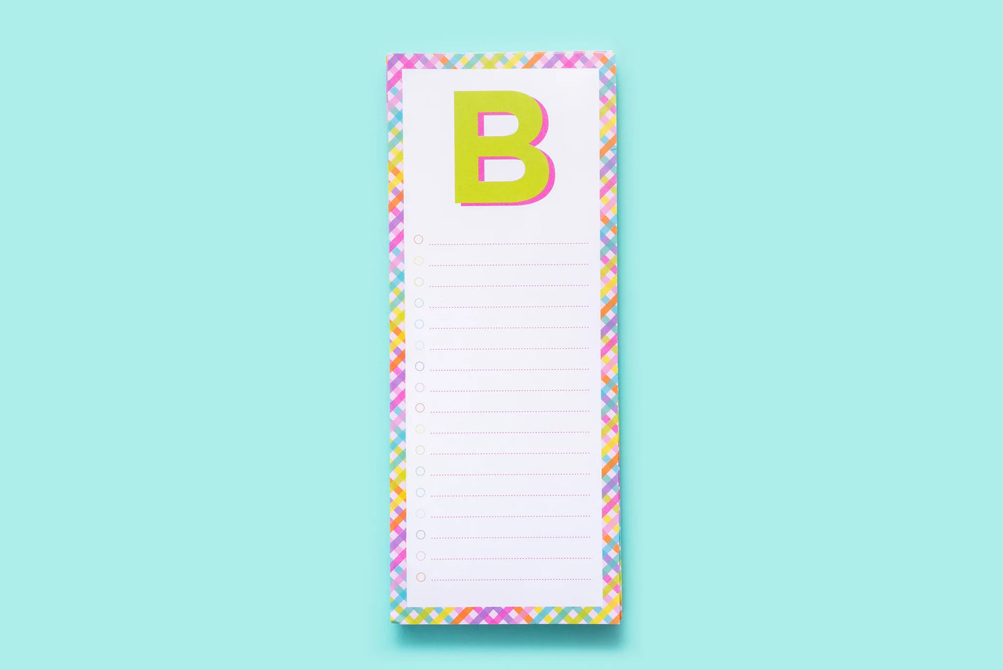 Colorful letter B notepad with rainbow border on light blue background