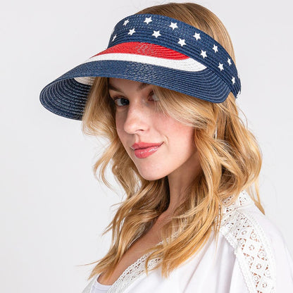 Woman wearing a patriotic visor with stars and stripes on a white background