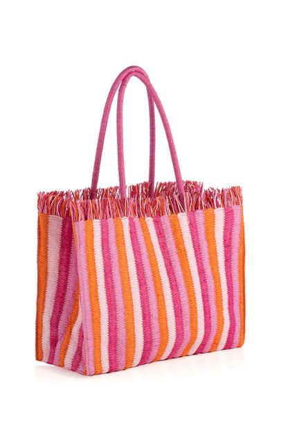 Pink and orange striped woven tote bag with fringe and double handles