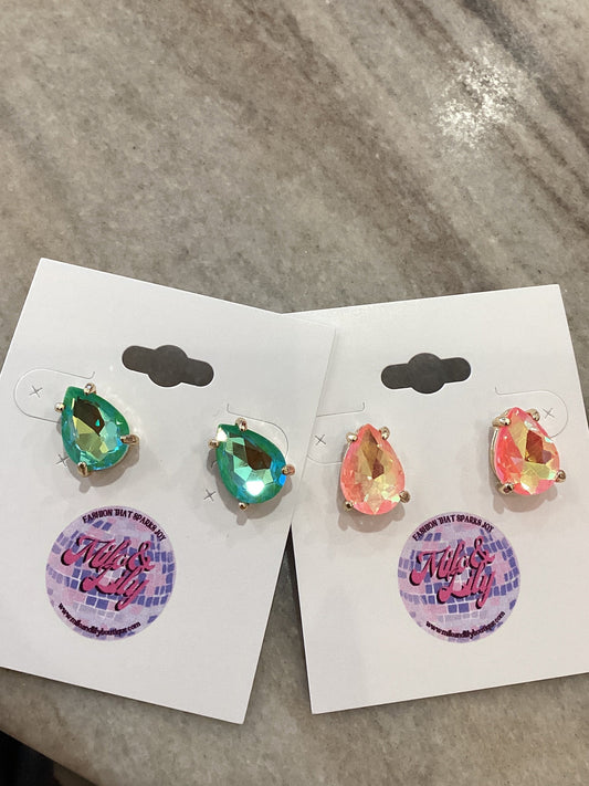 Iridescent teardrop stud earrings in green and peach on display cards with marble background