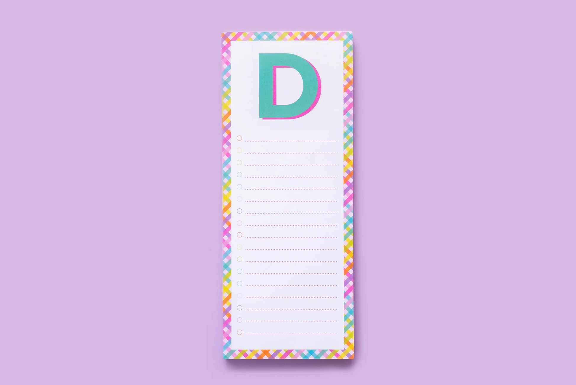Colorful letter D notepad with rainbow border on purple background