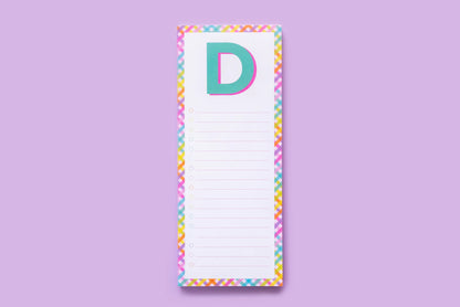 Colorful letter D notepad with rainbow border on purple background