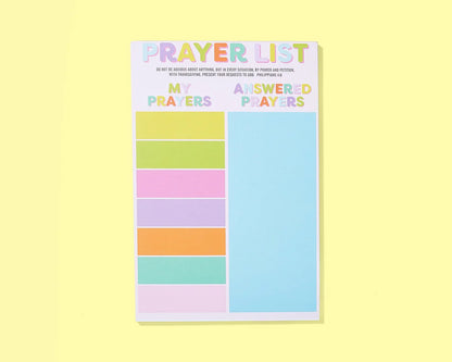 Notepad with colorful sections titled 'My Prayers' and 'Answered Prayers' on a yellow background