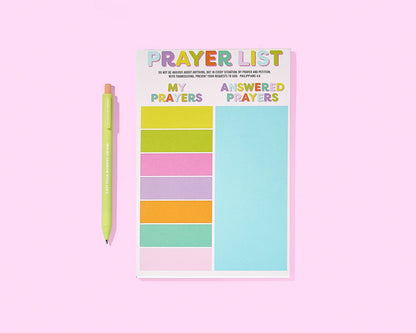Notepad with colorful sections labeled 'My Prayers' and 'Answered Prayers' on a pink background