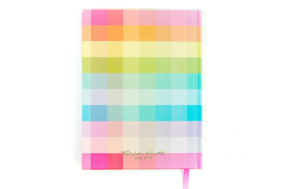 Colorful pastel checkered notebook with gold foil text and pink ribbon bookmark on white background