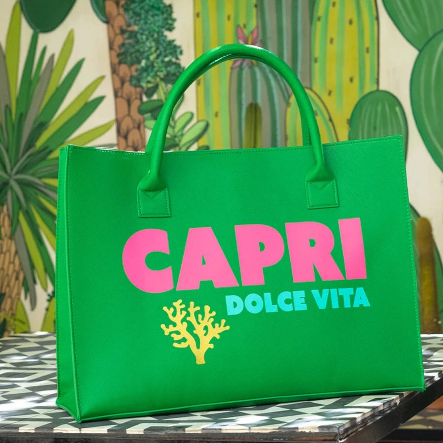 Bright green Capri Dolce Vita tote bag with pink and blue lettering, cactus background