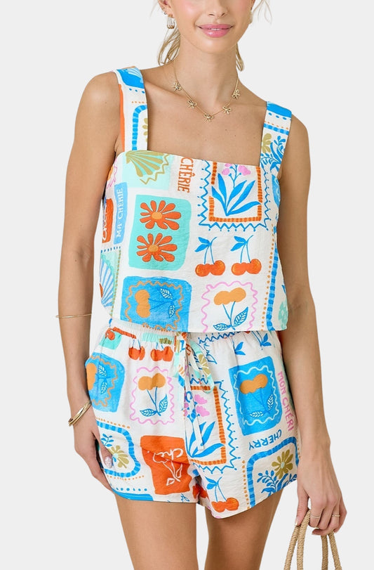 Woman wearing colorful floral patchwork print sleeveless romper with drawstring shorts