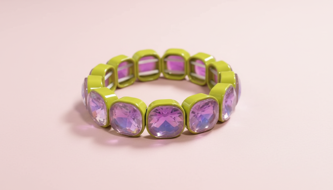 Green bracelet with pink gemstones on a light pink background