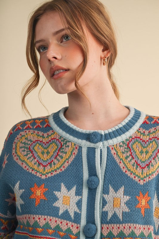 Woman wearing a patterned sweater with hearts and stars on a beige background