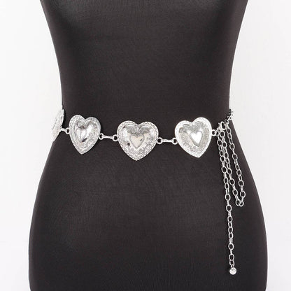 A silver heart-patterned waist chain displayed on a black mannequin torso against a white background.