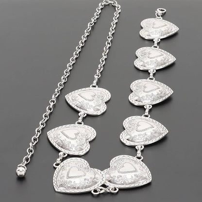 A silver heart-link chain necklace with multiple engraved heart charms, displayed on a dark gray background.