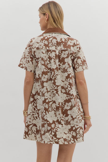 Back view of the Espresso Flora Dress showing espresso brown fabric with oversized ivory floral print and relaxed A-line silhouette – Milo & Lily Boutique.