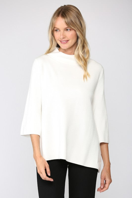 Woman wearing a white blouse and black pants on a plain background