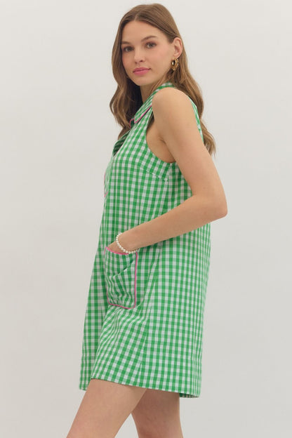 Woman wearing a green checkered dress on a plain background