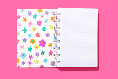 Notebook with colorful floral pattern on a pink background