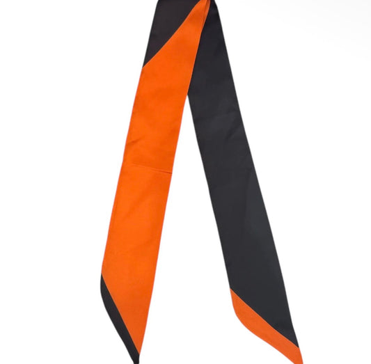 A long, narrow tie with a bold color-blocked design of bright orange and black, shown against a plain white background.