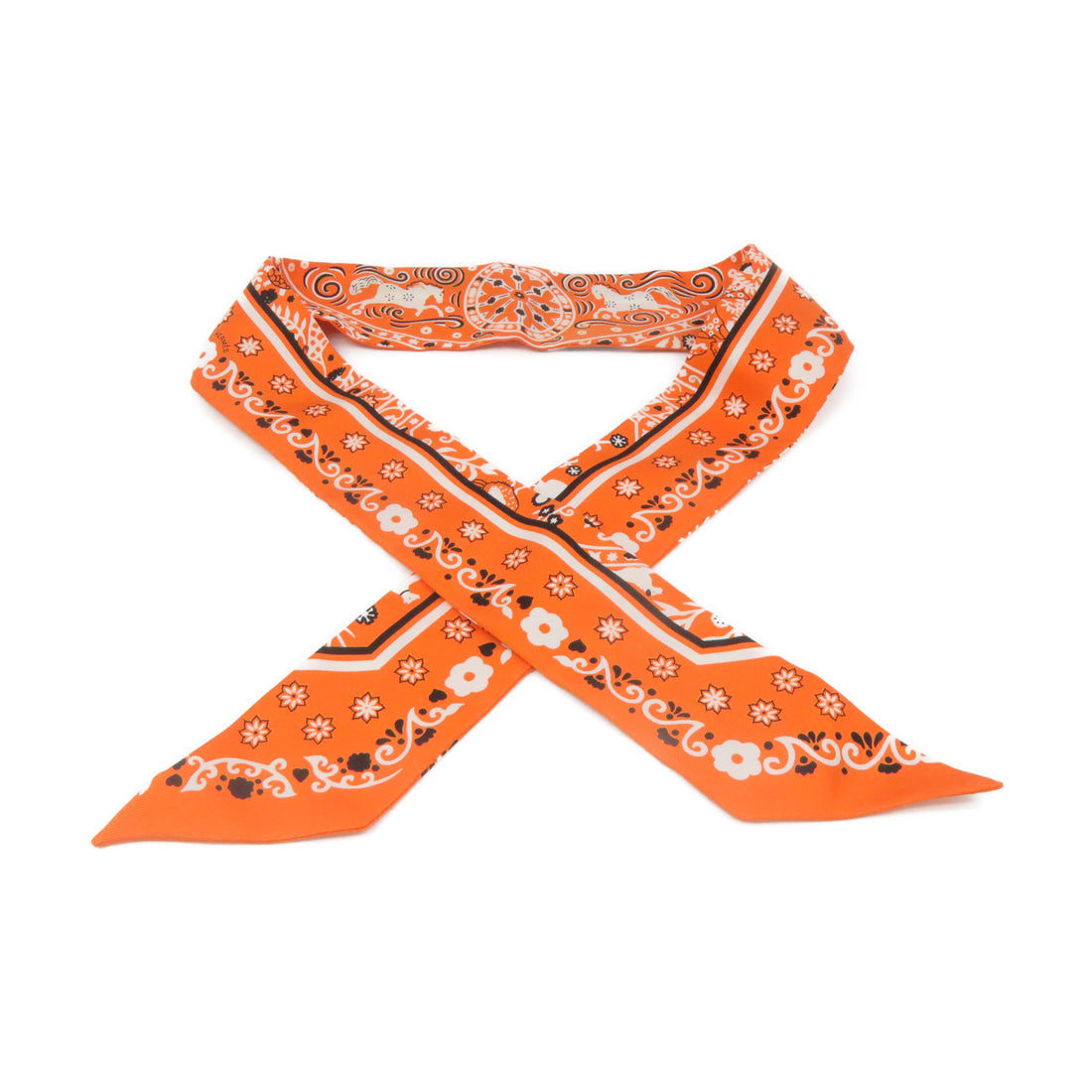 An orange bandana scarf with a white and black paisley pattern, tied in a cross shape on a plain white background.