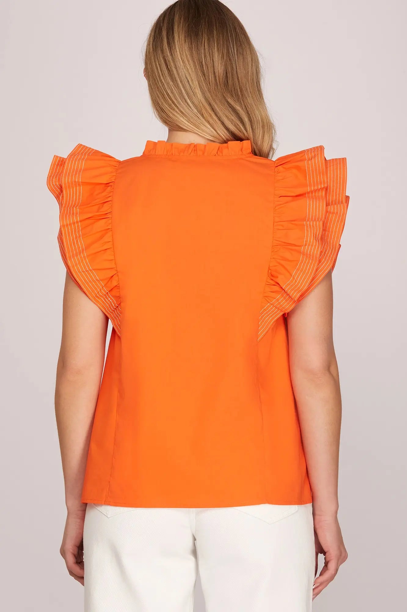 Back view of women’s orange statement ruffle sleeve blouse for OSU game day outfits