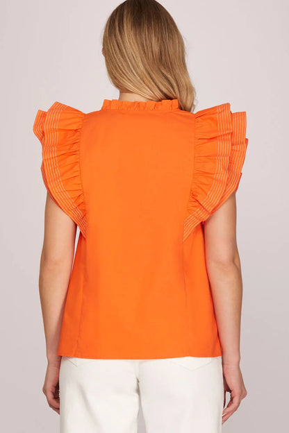 Back view of women’s orange statement ruffle sleeve blouse for OSU game day outfits