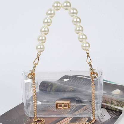 Clear handbag with a pearl handle on a magazine background
