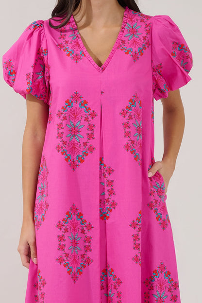 Pink dress with colorful embroidery on a plain background