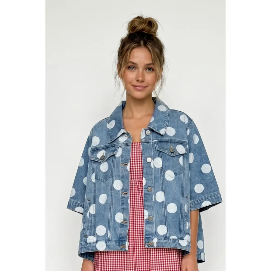 Woman wearing a polka dot denim jacket over a red checkered dress on a white background