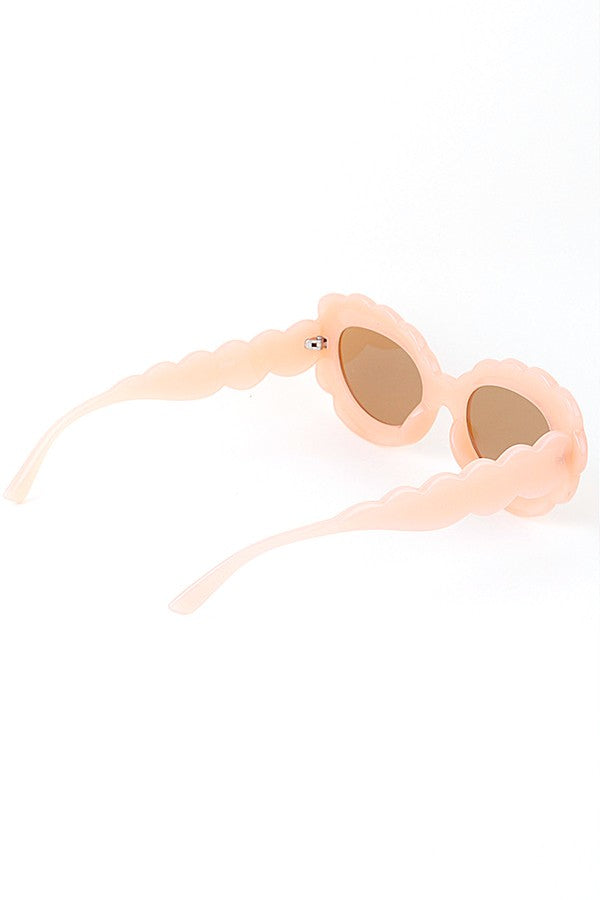 Peach scallop-edged sunglasses with round brown lenses on white background