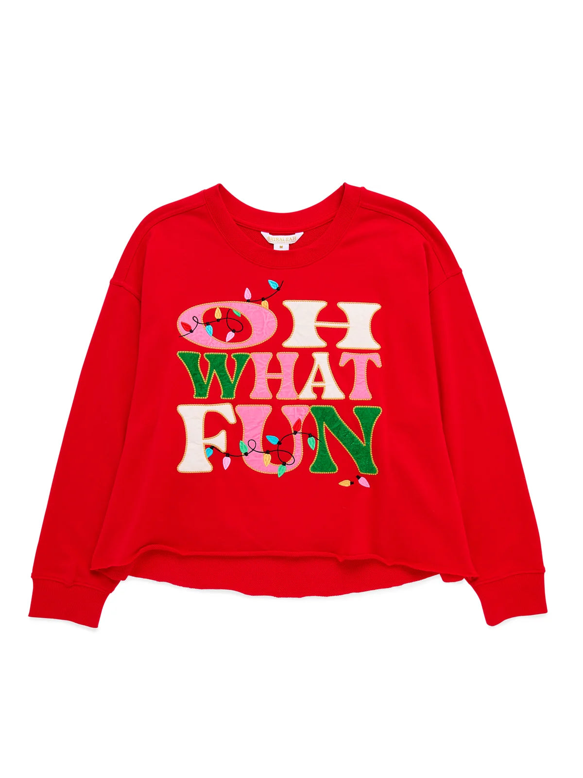A bright red long-sleeve sweatshirt featuring a colorful graphic text print that reads 'OH WHAT FUN' in cream, green, and pink letters with small heart and light bulb accents, displayed on a clean white background.
