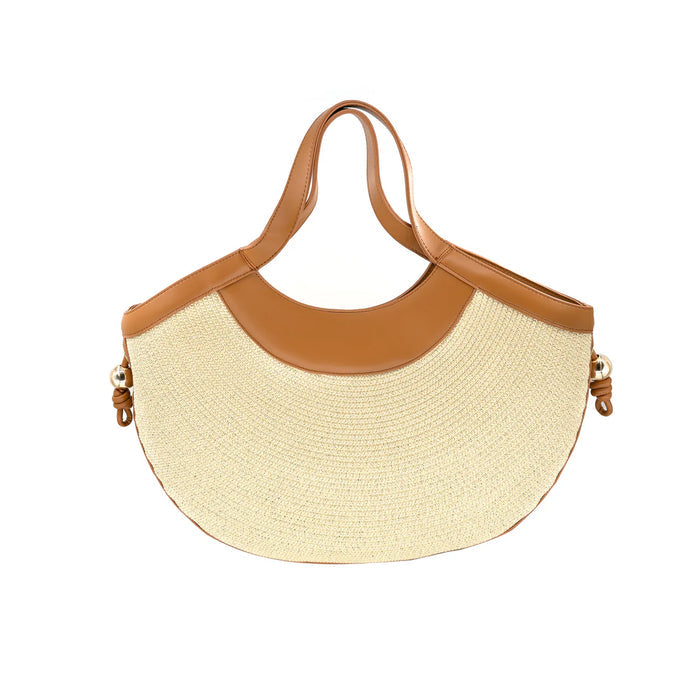 Straw handbag with brown leather accents on a white background